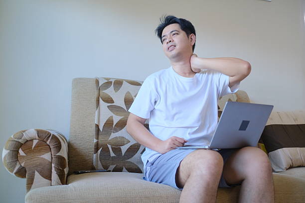 istock A man is sitting on a couch with a laptop in front of him 2246834024