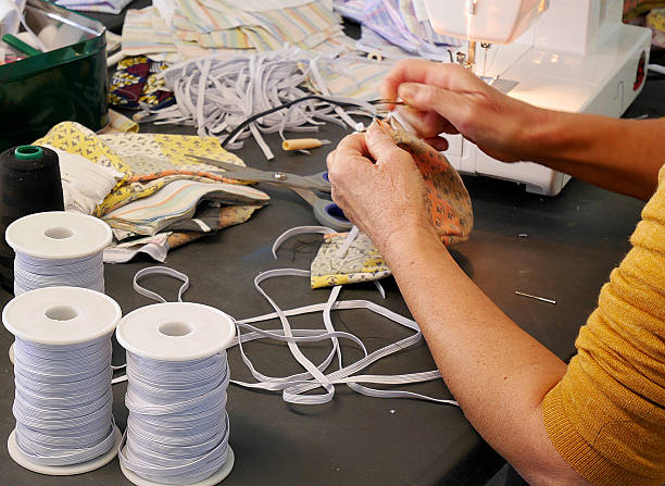 istock Close-up of a seamstress's hands sewing fabric 2246835163