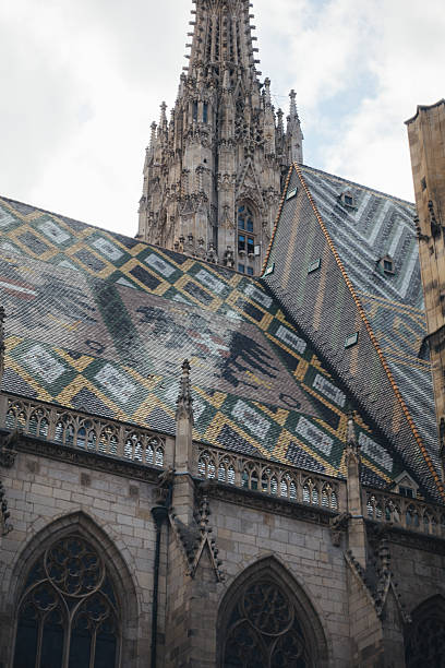 The iconic St Stephen's Cathedral features a stunning tiled roof and a towering spire, a testament to Gothic design