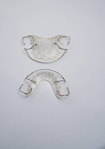 istock Dental retainers for upper and lower jaws after braces or for teeth alignment before orthodontic treatment showing clear removable dental plates 2246839853