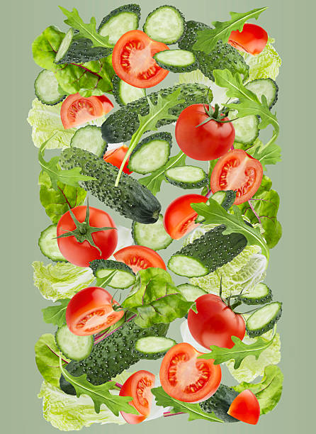 istock Fresh organic vegetables as DNA spiral shape. Salad ingredients - chinese cabbage, tomatoes, leafy greens, cucumbers fly or fall as flow on green background. Ideal for healthy eating, diet menu. 2246841798