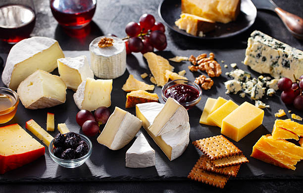 istock Assortment cheese platter with grapes, crackers and jam. Dark grey background. Close up. 2246845659