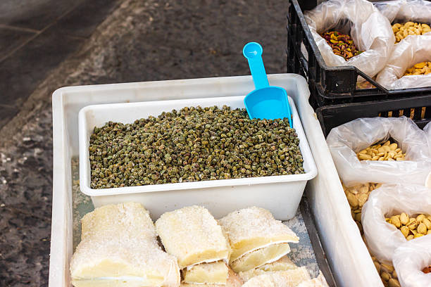 Colorful Market Display With Dried Goods, Nuts, And Sweet Rolls In White Tubs At Outdoor Stall