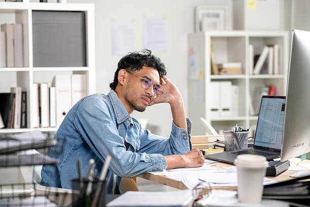 istock Young Businessman looking stressed and tired, Businessman mental burnout while working 2246847221