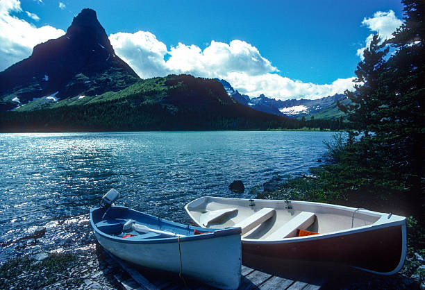 Glacier National Park - Two boats rest on the shore by Swiftcurrent Lake - 1989. Scanned from Kodachrome 64 slide.