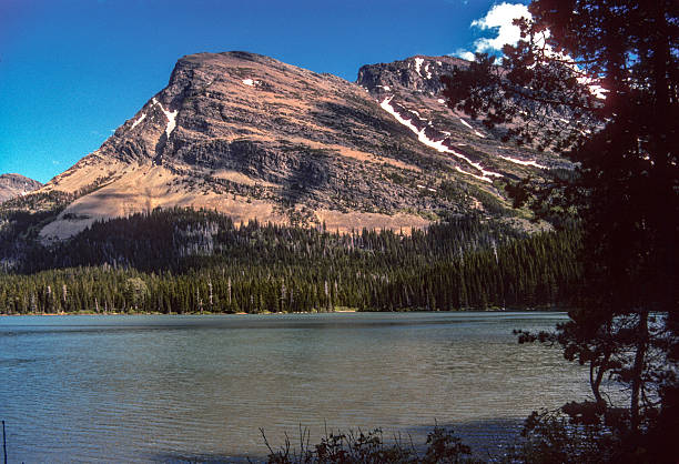 Glacier National Park - View across Swiftcurrent Lake and the sun-kissed mountain beyond - 1989. Scanned from Kodachrome 64 slide.