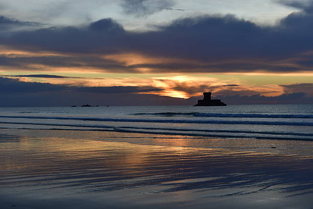 Autumn sunset on the beach with Rocco tower.