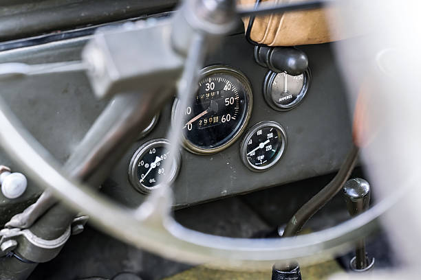 Lisbon, Portugal - Sep 29, 2024: Green interior with steering wheel, gear stick and car dashboard of vintage Ford A Tudor Sedan in selective focus. Keys in ignition switch. Ford Motor Company, USA.