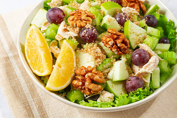 istock Fresh Waldorf salad, celery stalk with chicken, apple and walnuts, grapes, herbs, homemade, without people, 2246856160