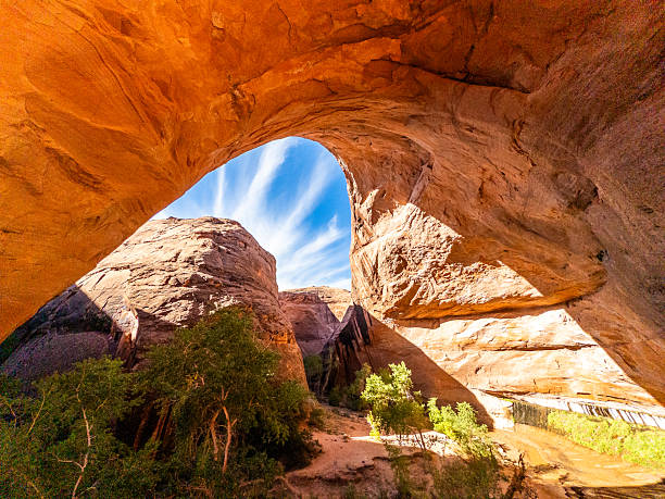 istock Sunlight pouring through Jacob Hamblin Arch with blue sky and streaked clouds 2246861288