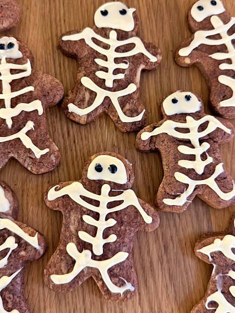 istock Image of spooky halloween skeleton cookies decorated with white icing, scary-themed biscuits 2246861569