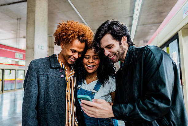 istock Friends using mobile phone together on the subway station 2246862631