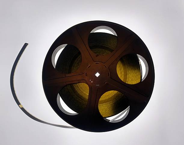 A detailed close-up of a classic 35mm film reel, showcasing the nostalgic texture and analog beauty of traditional cinema. Perfect for themes related to filmmaking history, retro media, analog technology, cinematography, and vintage movie production.