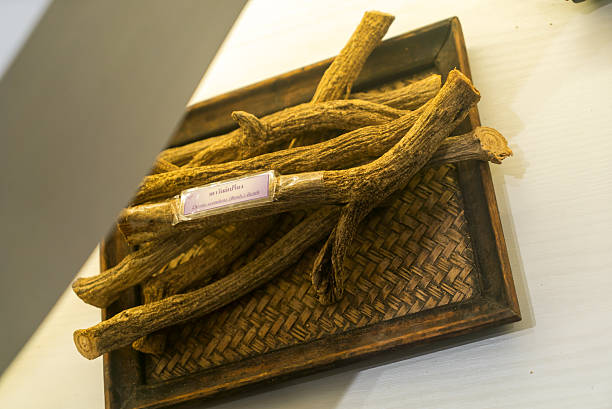 A wooden tray holds naturally dried roots, showcasing their unique textures and earthy tones. Perfect for traditional and herbal displays in home decor.