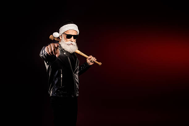 istock Rocking Santa with leather jacket points forward in bold holiday bearded elder rocker style ready for christmas winter celebration 2246867461