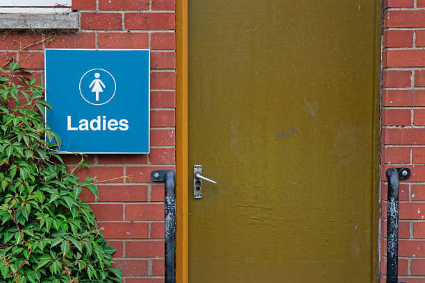 Toilet sign at public facility outdoors in park UK
