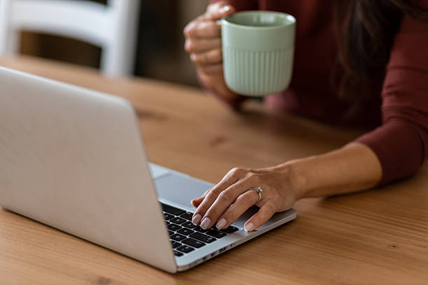 istock Close-up of woman working with coffee mug 2246874035