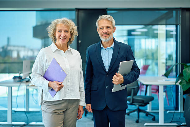 istock Business partners smiling in modern office environment 2246882008