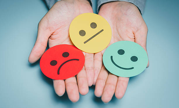 istock Hands presenting three mood faces, emotional state variety, anxiety awareness, stress level check, mental health reflection, psychology support guidance, wellbeing improvement concept 2246882920