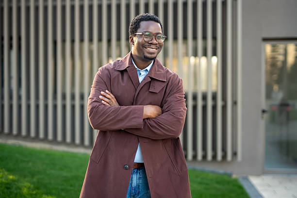 istock African man smiling wearing eyeglasses and trench coat 2246884282