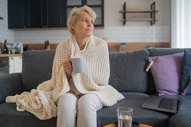 istock Woman relaxing at home, wrapped in a cozy blanket. 2246885047