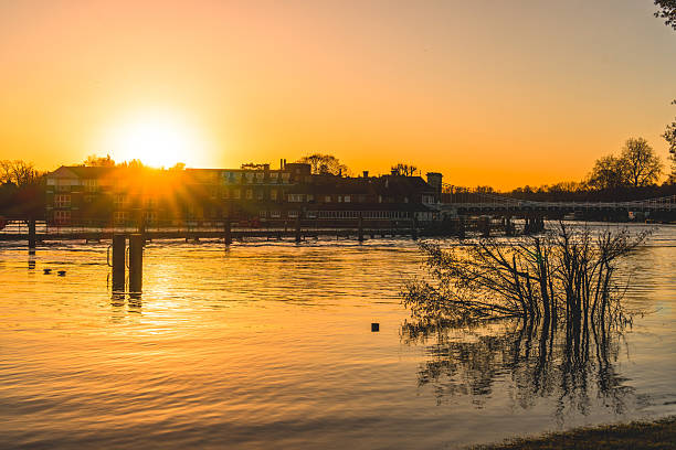 Orange sunlight reflecting on the water of river thames at sunset