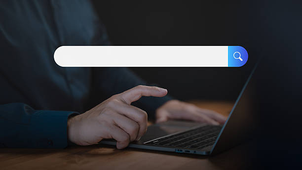 istock Adult man using a laptop searching on the internet. SEO technology networking, representing online browsing, information seeking, and digital search technology in a modern workspace. 2246888052