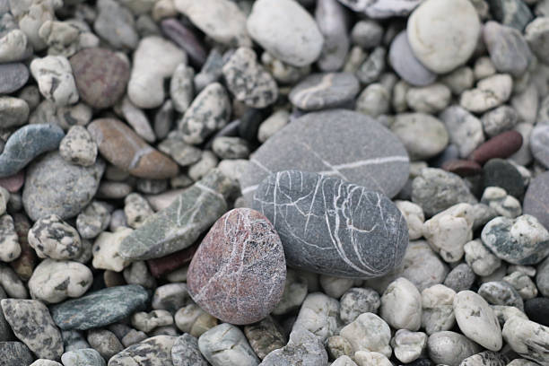 istock Close-up of colorful, naturally polished pebbles with unique patterns and textures, creating an organic and calming composition ideal for backgrounds, nature themes, and design projects. 2246888441