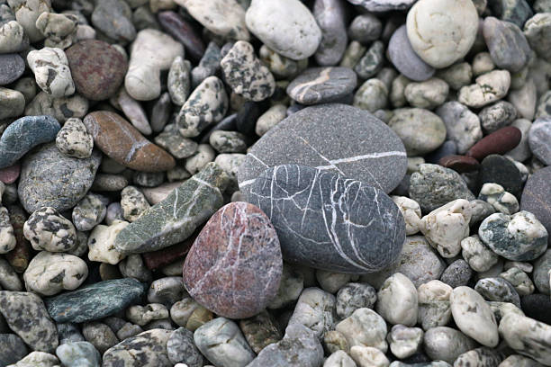 istock Close-up of colorful, naturally polished pebbles with unique patterns and textures, creating an organic and calming composition ideal for backgrounds, nature themes, and design projects. 2246888462