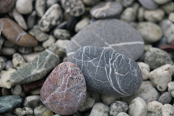 istock Close-up of colorful, naturally polished pebbles with unique patterns and textures, creating an organic and calming composition ideal for backgrounds, nature themes, and design projects. 2246888792