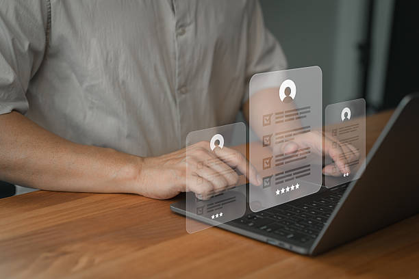 istock Digital checklist and survey form displayed on a laptop screen with user interaction. Hands typing on keyboard with rating stars and digital interface for feedback, data entry, and assessment. 2246888817