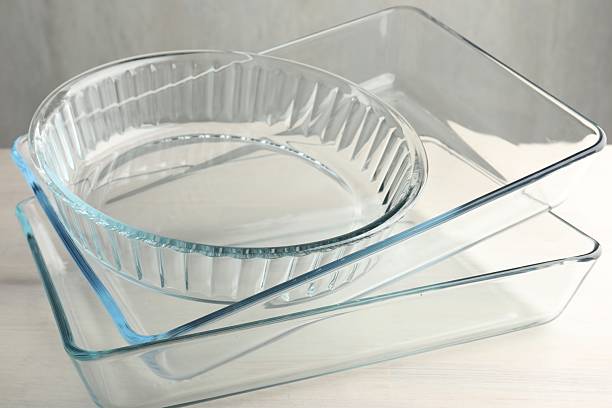 istock Different glass casseroles on light wooden table, closeup 2246892430