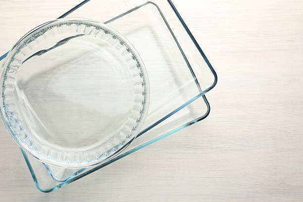 istock Different glass casseroles on light wooden table, top view. Space for text 2246892521