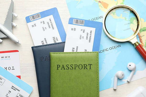 istock Travel agency. Flat lay composition with flight tickets on light wooden table 2246893028