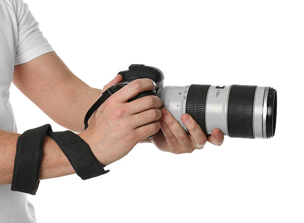 istock Photographer holding modern camera on white background, closeup 2246893157