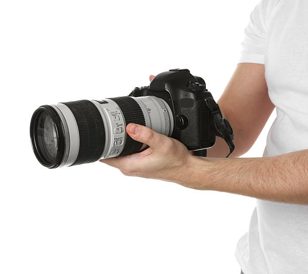 istock Photographer holding modern camera on white background, closeup 2246893159