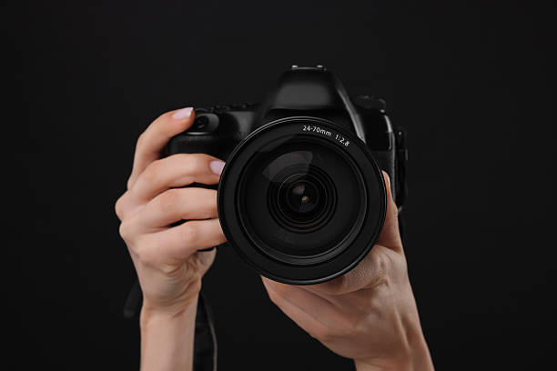 istock Photographer with camera on black background, closeup 2246893209
