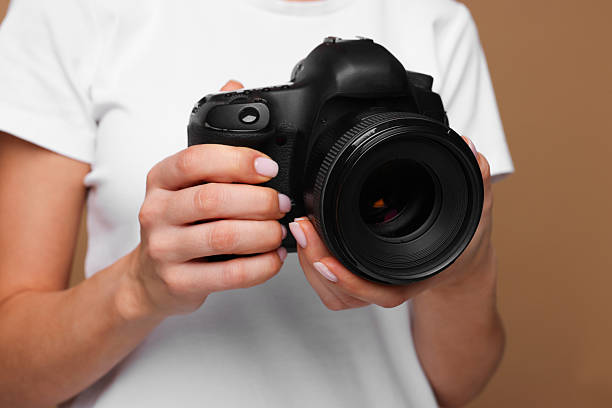 istock Photographer with camera on brown background, closeup 2246893223