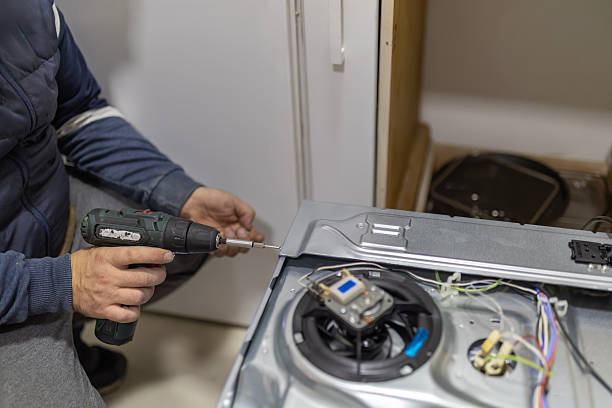istock Technician repairing kitchen appliance with electric screwdriver 2246894079