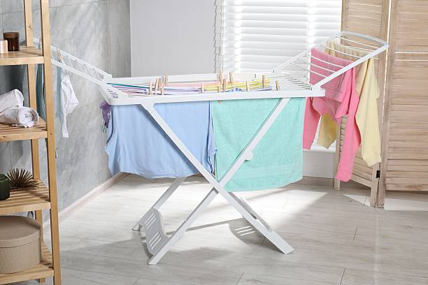 istock Drying rack with fresh clean laundry at home 2246896373
