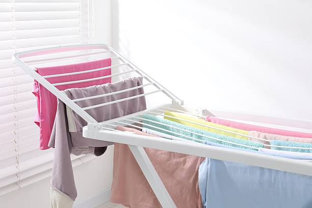 istock Drying rack with fresh clean laundry at home, closeup 2246896377