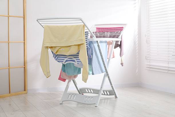 istock Drying rack with fresh clean laundry at home 2246896381