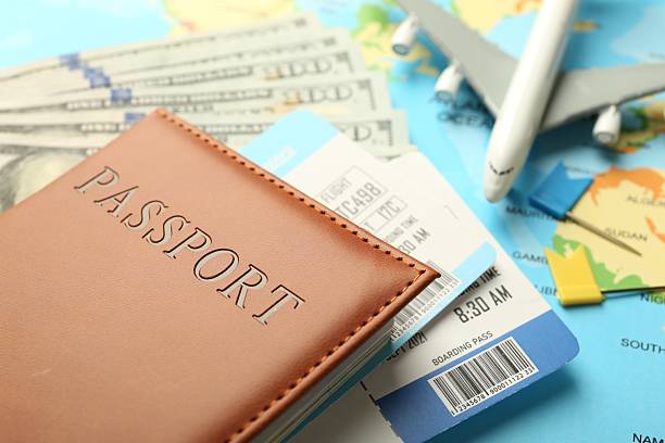istock Passport with tickets, money and plane model on world map, closeup 2246897092