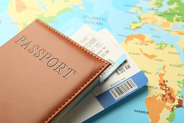 istock Passport with tickets on world map, closeup 2246897100