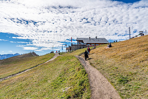 Tourists are enjoying the view of Seceda mountains in the Dolomites, South Tyrol, Italy.