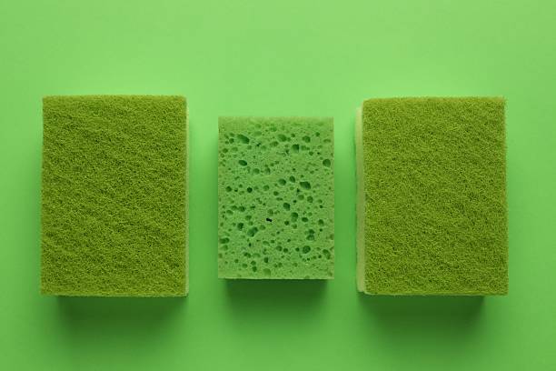 istock Group of sponges on green background, flat lay 2246897886