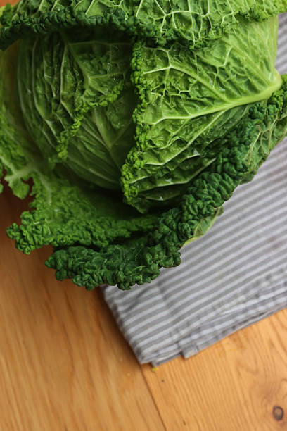 istock Brassica oleracea.  Savoy cabbage on gray napkin on  table 2246917628