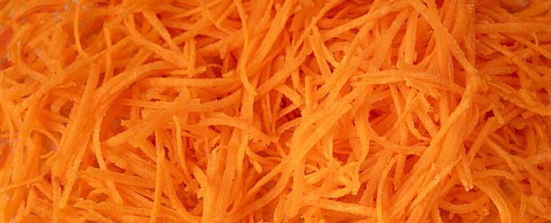 istock Fresh Finely Grated Carrots Textured Background, Raw Carrot Pieces Closeup Pattern 2246920827
