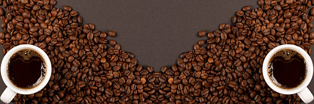 istock Hot coffee cup and coffee beans on black background top view 2246920968