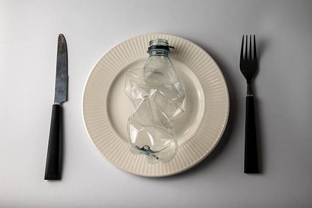 Plastic pollution concept photo - crushed bottle on a plate